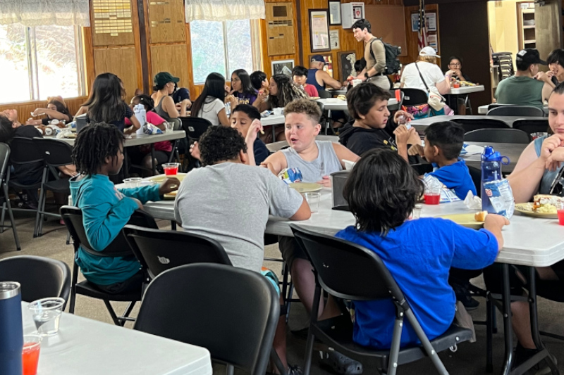 Campers enjoying a meal together at the dinning area of Jay Nolan Camp